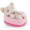 Soft toy kitty with leopard print sleeping in basket